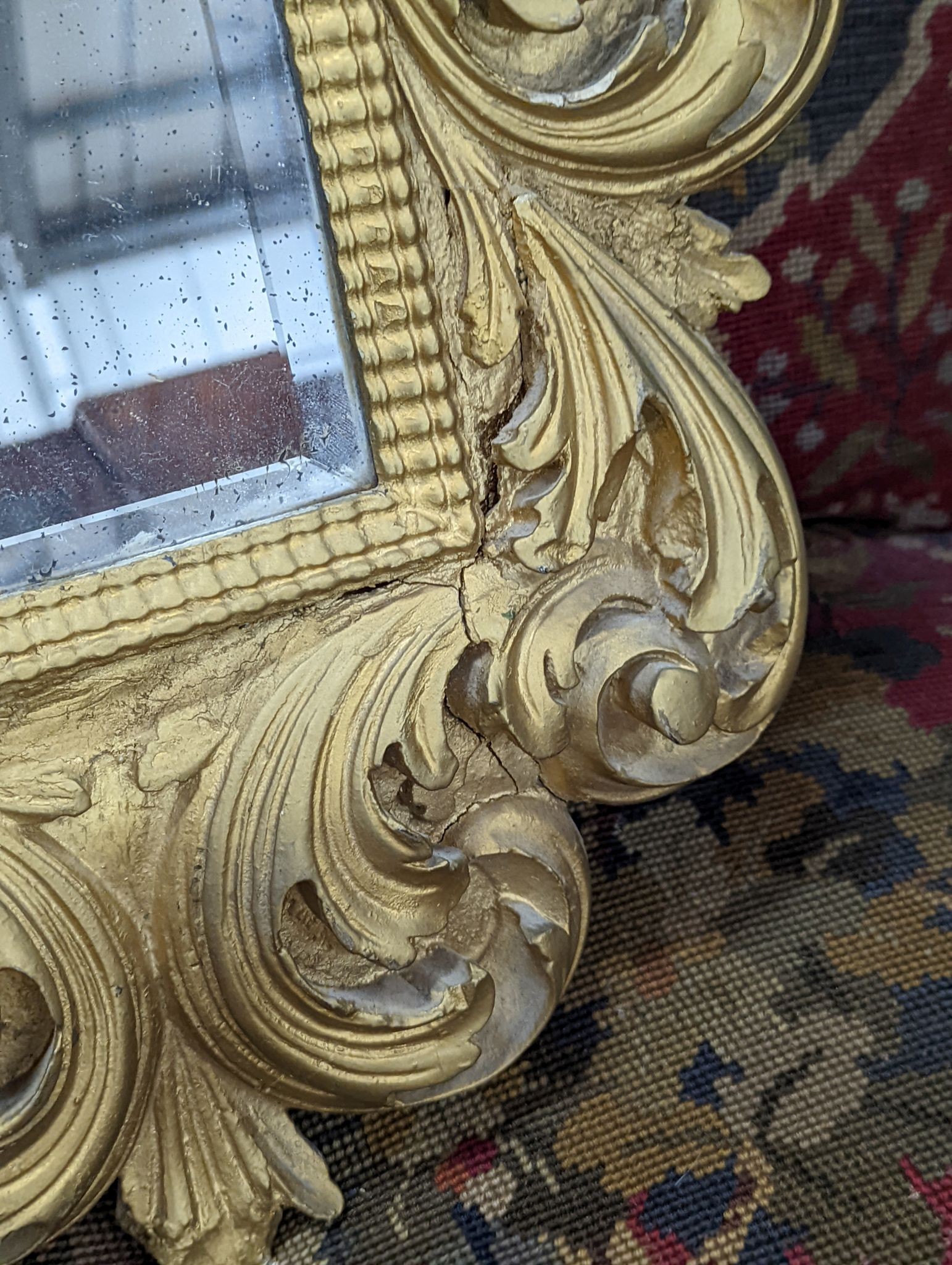 A small Florentine style gilt plaster acanthus scroll wall mirror, width 38cm, height 53cm